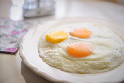 High angle view of fried egg served in plate on table