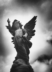 Low angle view of statue against cloudy sky