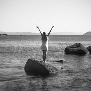 Rear view of woman standing in water