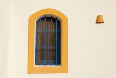 Low angle view of window on white wall