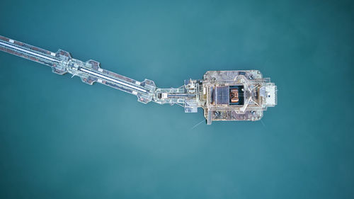 High angle view of telephone pole against blue sky