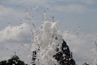 Close-up of water splashing against sky