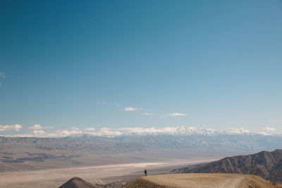 Scenic view of desert against blue sky