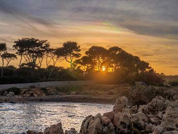 Scenic view of rocks against sky during sunset