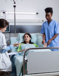 Doctor consulting female patient at hospital