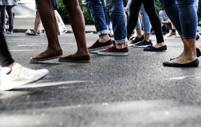 Low section of people walking on road