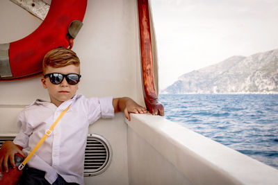 Small boy cruising on passenger ship on summer vacation.