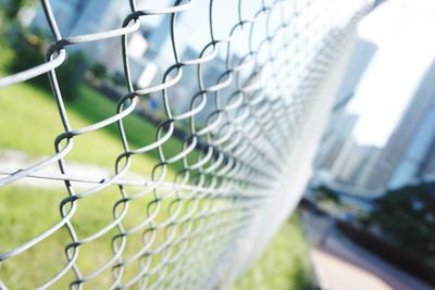 Close-up of soccer field seen through chainlink fence