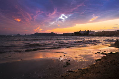 Scenic view of beach against sky during sunset