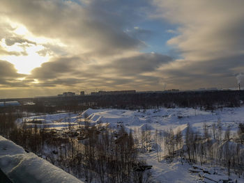 Frozen lake against sky during winter