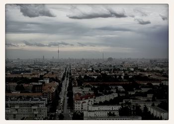 Cityscape against cloudy sky