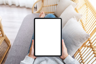 Midsection of woman using digital tablet on table