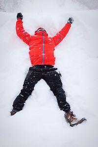 Rear view of boy playing on snow