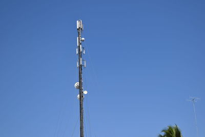 Low angle view of power lines against clear blue sky