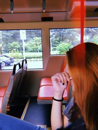 Midsection of woman sitting in bus