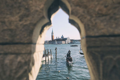 Reflection of people on boat in sea