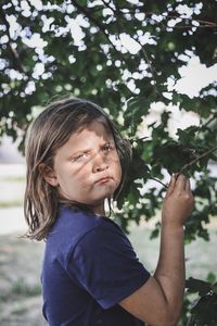 Portrait of girl looking at tree