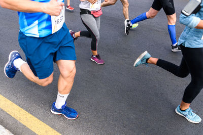 Low section of people running on road