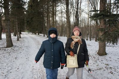 Woman walking with daughter on snow