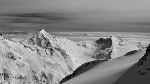 Aerial view of snowcapped mountains against sky