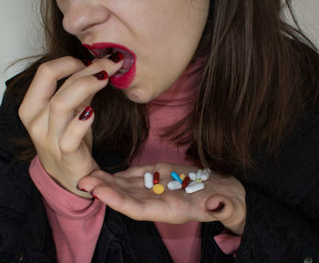 Midsection of woman having medicines