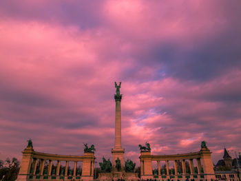 Low angle view of monument against cloudy sky