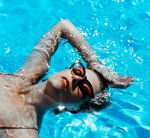 Portrait of young man swimming in pool