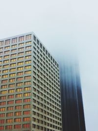 Low angle view of office buildings against clear sky