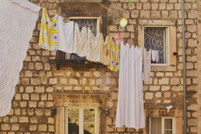 Low angle view of clothes drying against building