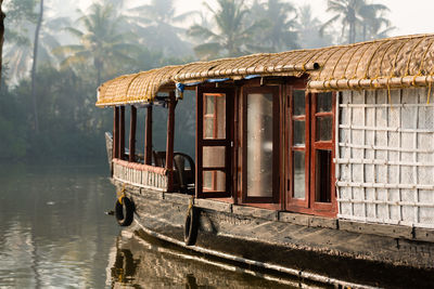 Built structure by lake against trees