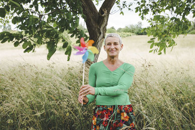 Portrait of smiling young woman holding umbrella