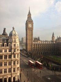 Clock tower in city against sky