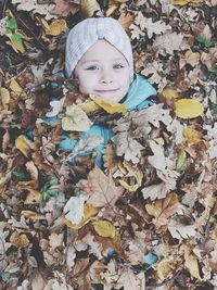 Portrait of cute boy with autumn leaves