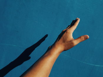 Low section of person legs on swimming pool