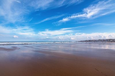 View of beach against cloudy sky