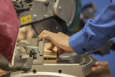 Midsection of carpenter working in workshop