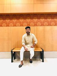 Portrait of young man sitting on chair