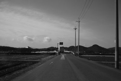 Empty road leading towards mountains