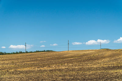 Scenic view of field against blue sky