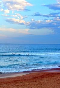 Scenic view of beach against sky during sunset