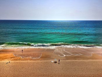 Scenic view of beach against clear sky