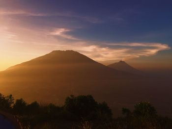 Scenic view of silhouette mountains against sky during sunset