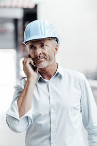 Midsection of man working with smart phone