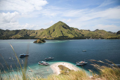 Scenic view of bay and mountains against sky