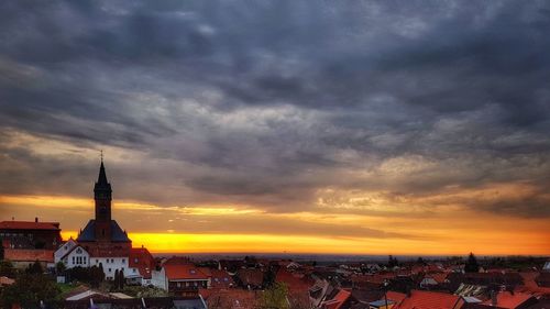 View of cityscape against cloudy sky