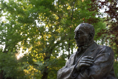 Low angle view of statue against trees