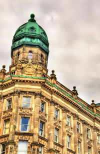 Low angle view of historical building against cloudy sky