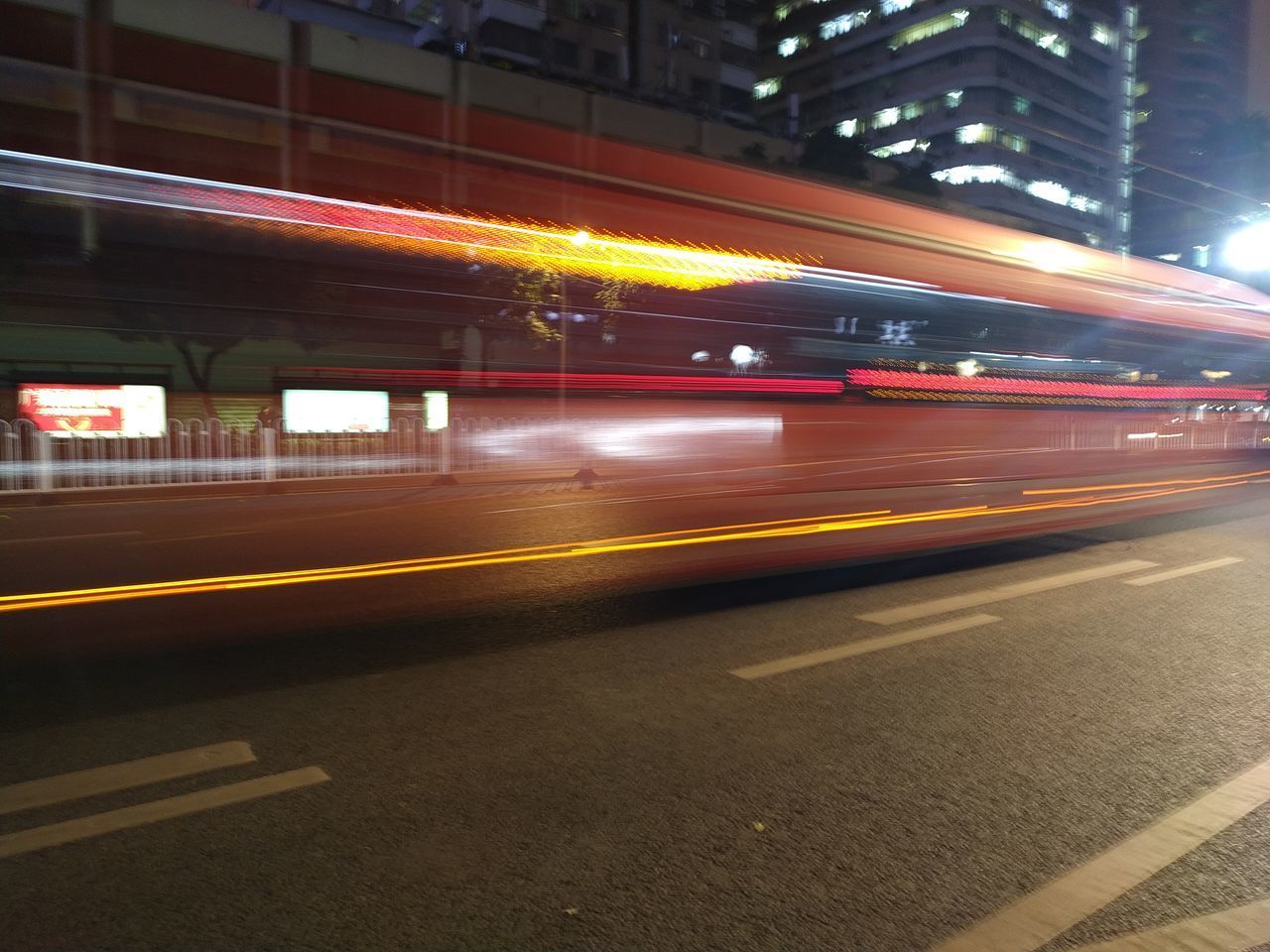 LIGHT TRAILS ON ROAD AT NIGHT