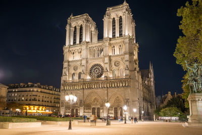 Low angle view of illuminated building against sky at night