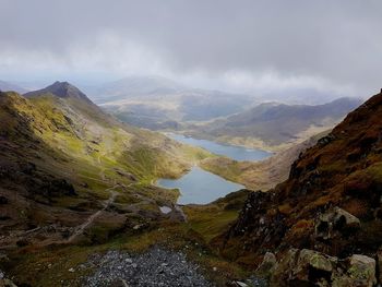 Scenic view of mountains against cloudy sky